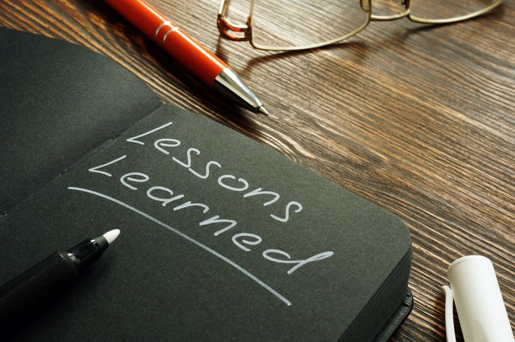 Lessons learned mark on the black page.